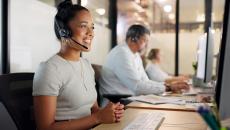 Woman works IT help desk in a support center